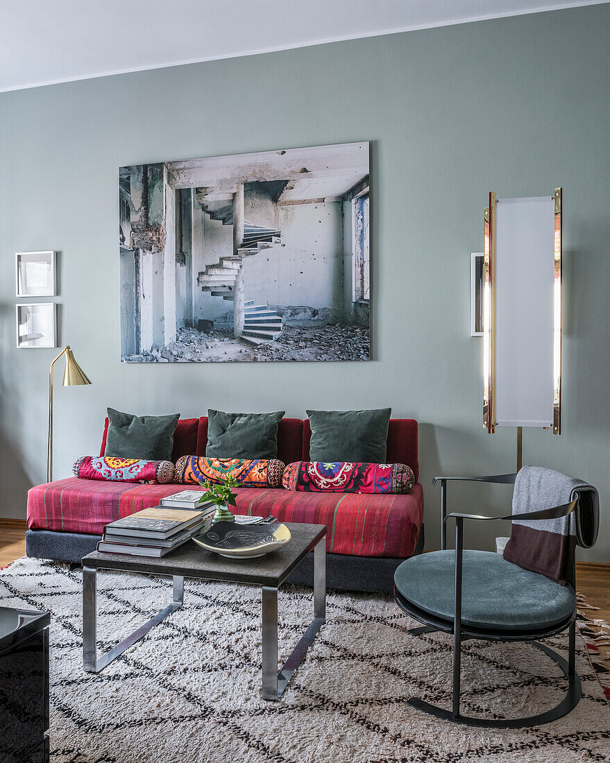 Large photo above bright daybed upholstered in Moroccan fabric, the daybed is flanked by light and lamp