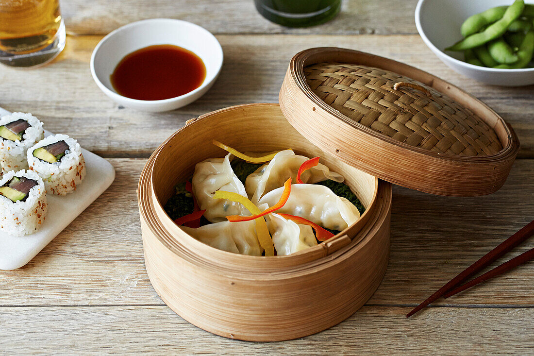 Gyoza (Japanese dumplings) with pepper strips in a bamboo basket