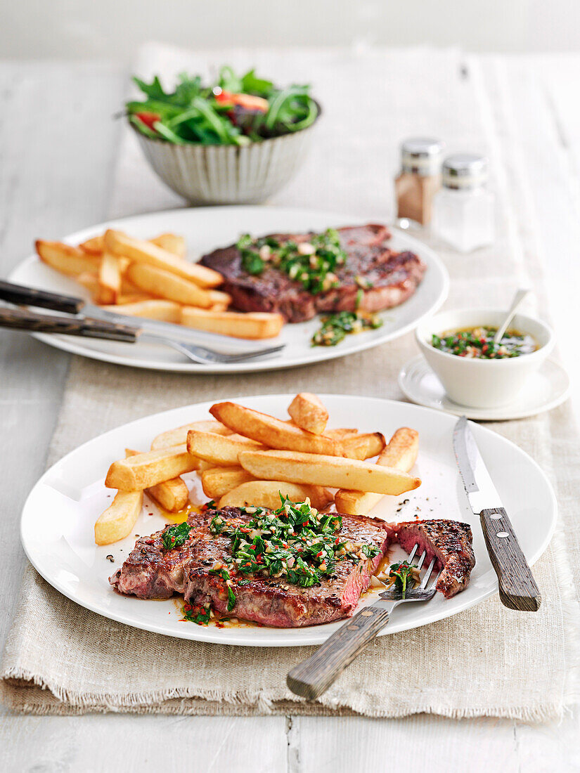 Steak with chimichurri sauce and fries