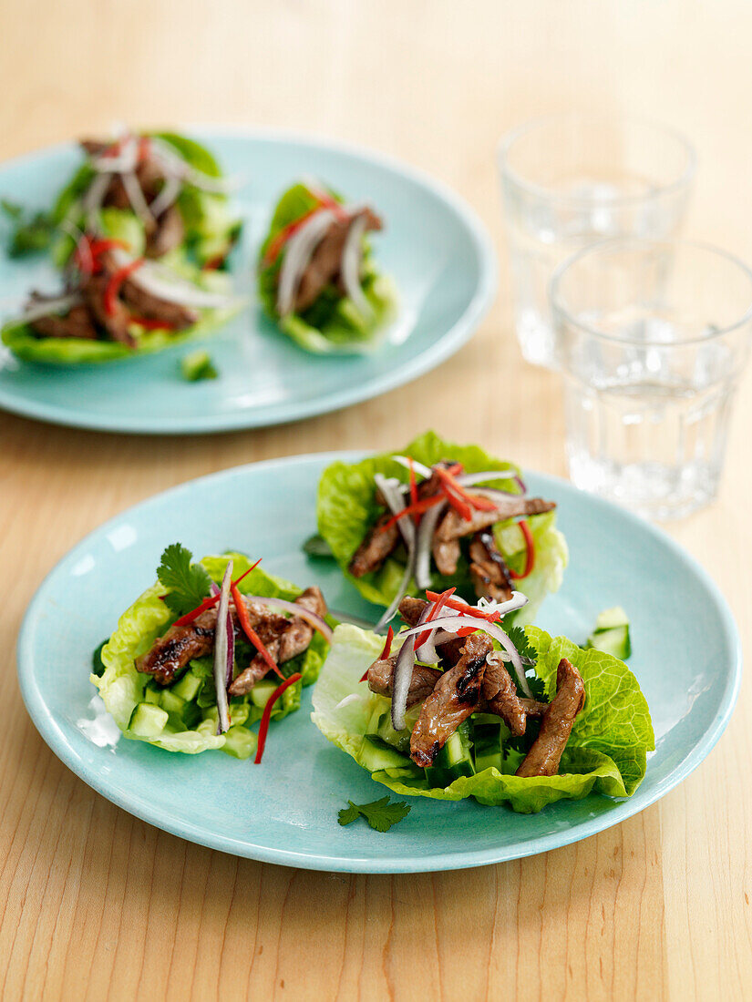 Teriyaki beef served in lettuce leaves