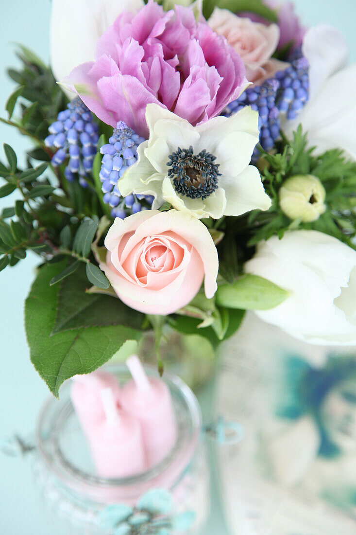 Spring bouquet of tulips, roses, grape hyacinths and anemones
