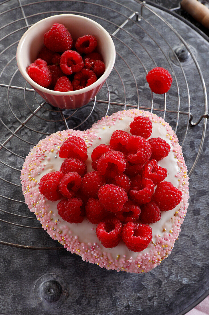 Heart-shaped cake with raspberries