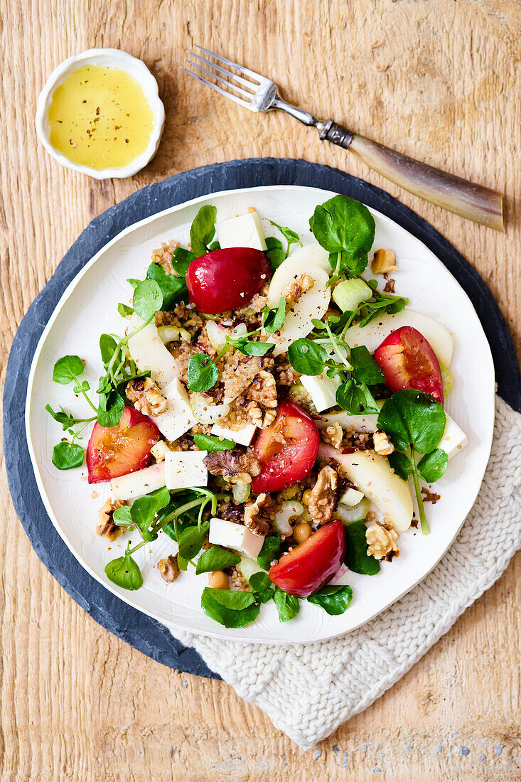 Warm three grain salad with roasted plums, pears and walnuts