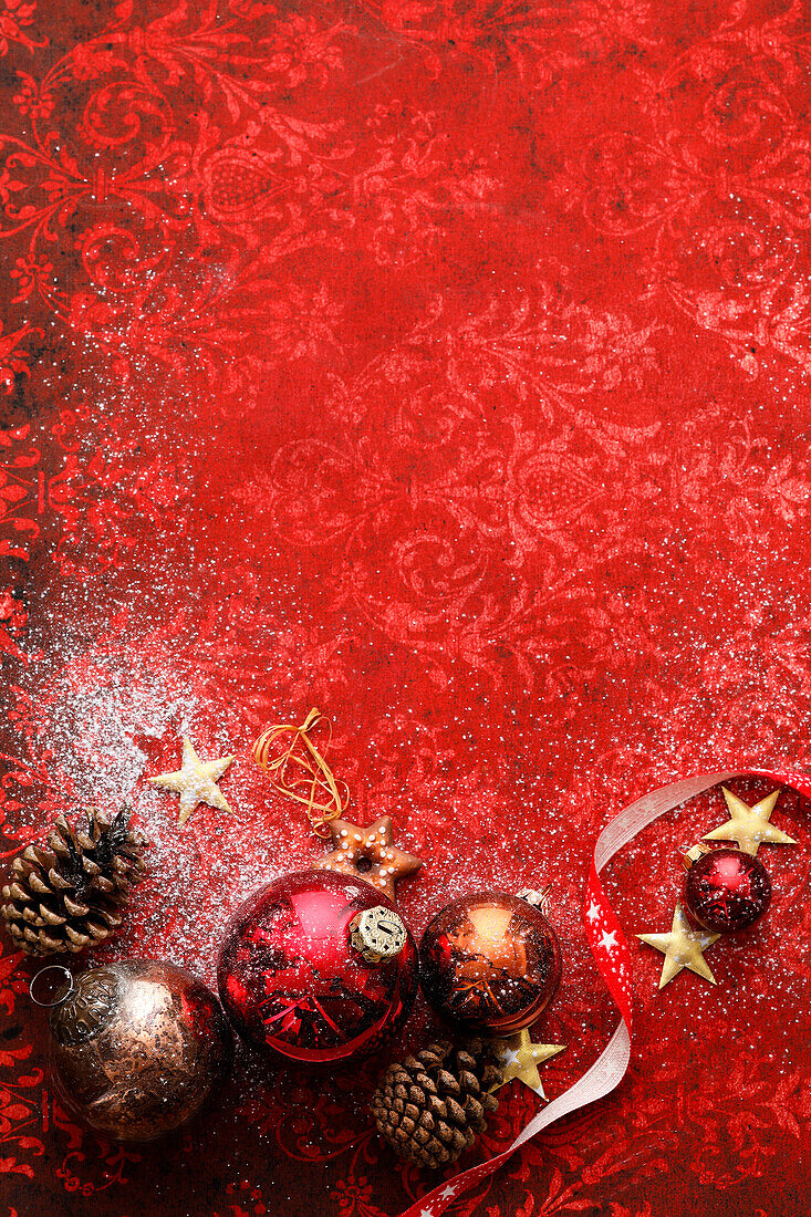 A Christmas background with Christmas baubles in shades of red