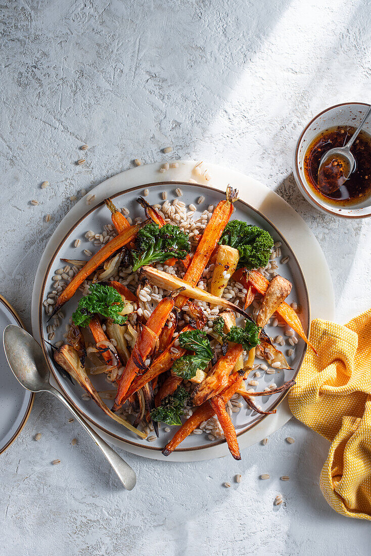 Roasted young carrot, parsnip, sweet potato, onion and kale with pearl barley and chilli oil