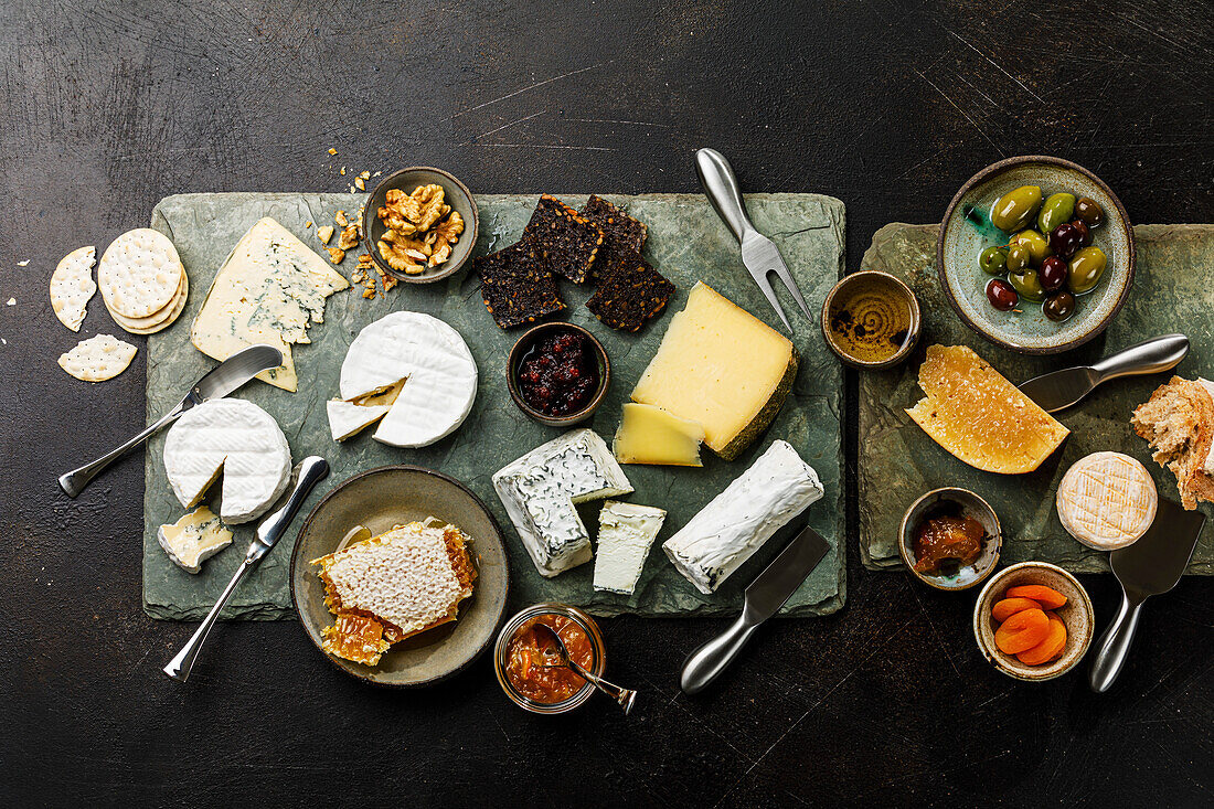 Cheese Plate with different types of farm cheese Snack assortment on slate serving board