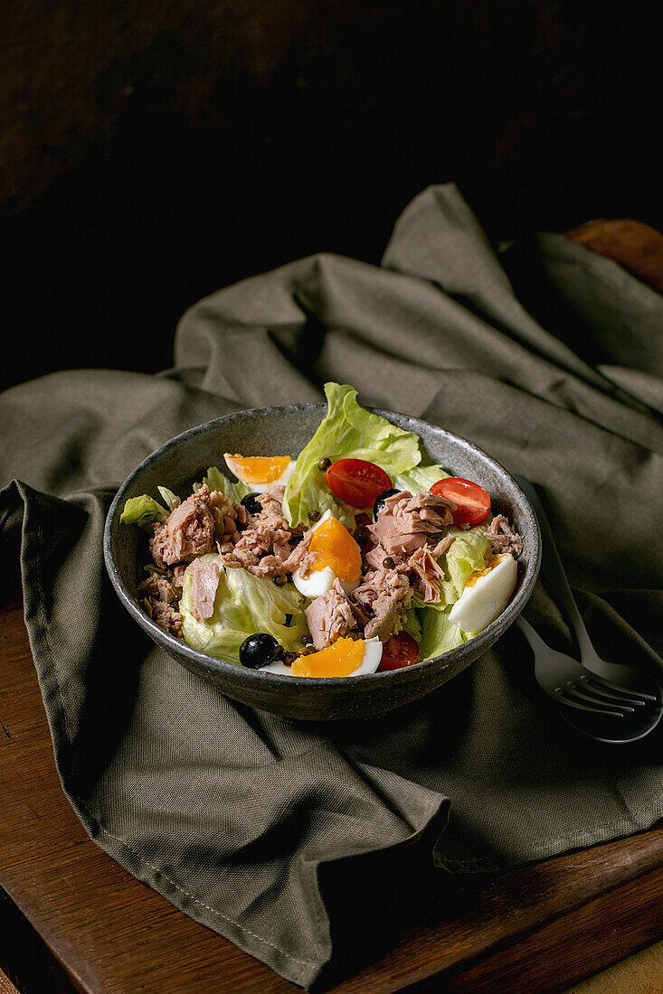 Traditional french nicoise salad with canned tuna fish, olives and eggs