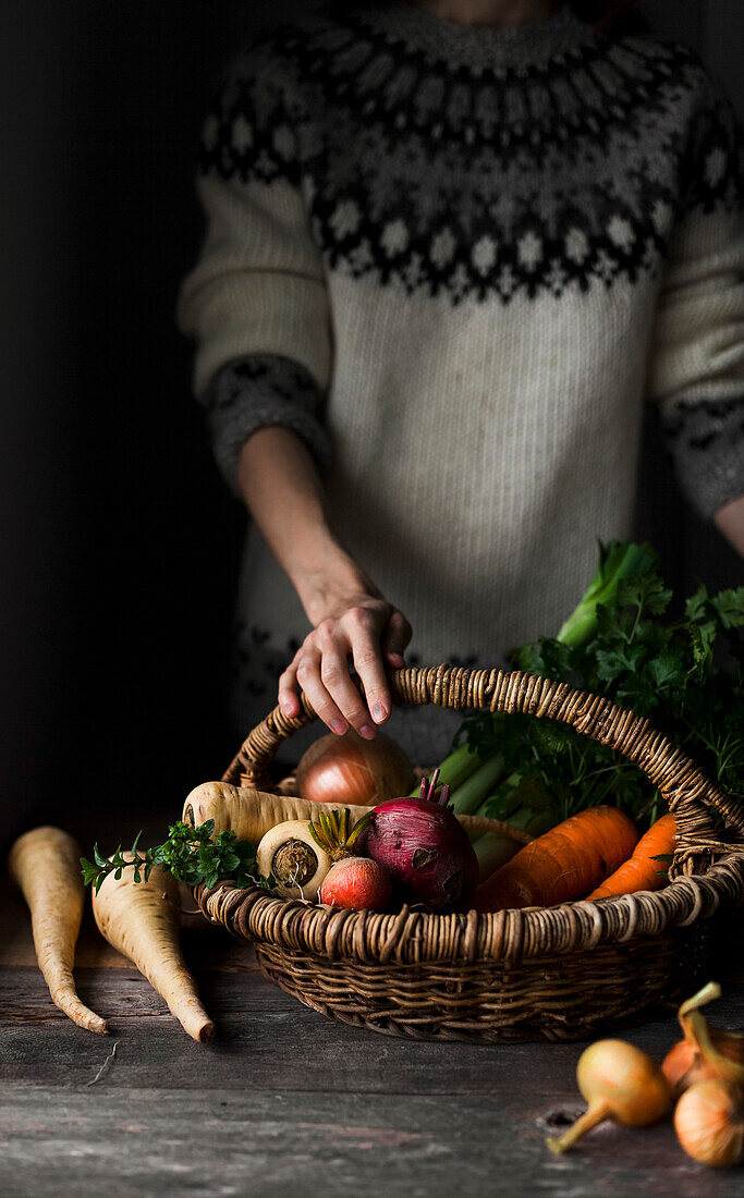 A farmer with a basket of fresh autumn vegetables