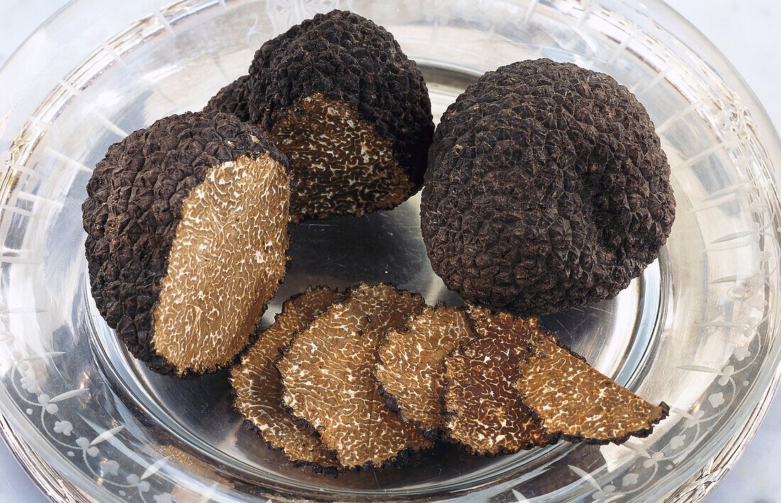 Truffles and truffle slices on a glass plate