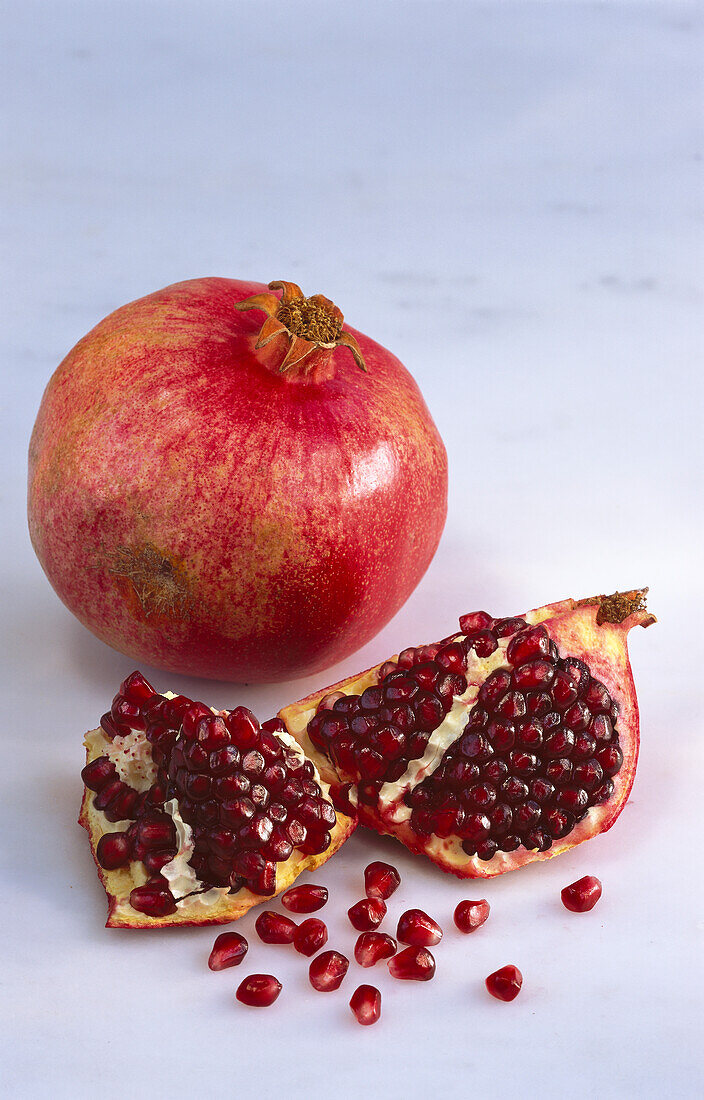 Pomegranate, whole and broken into seeds