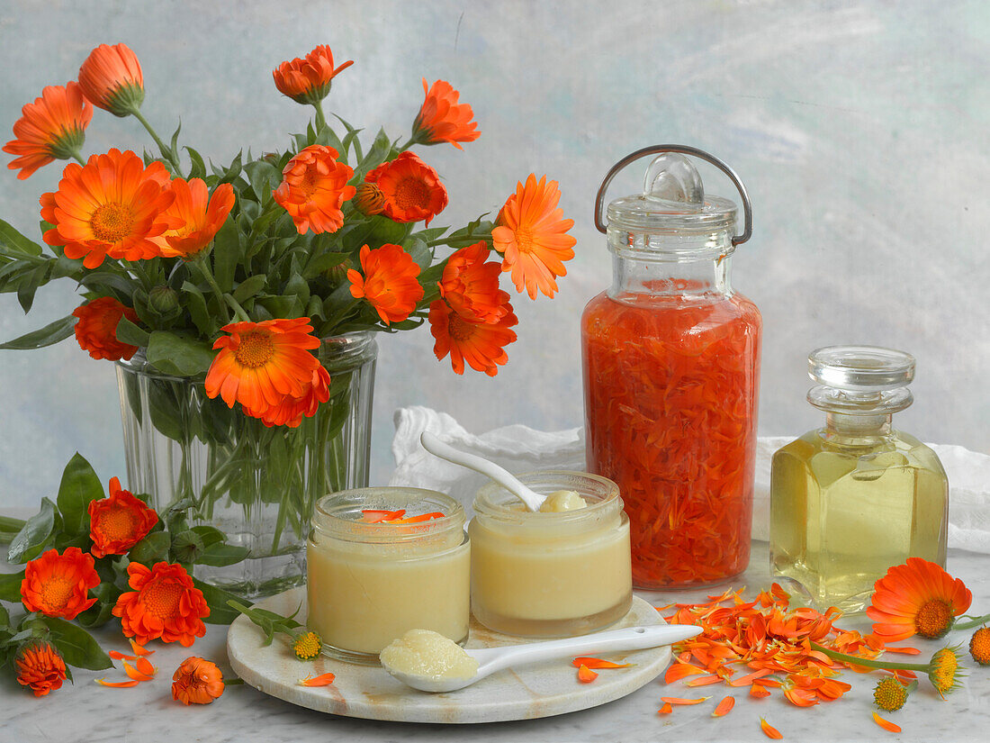 Still life with marigolds, marigold oil, and marigold ointment