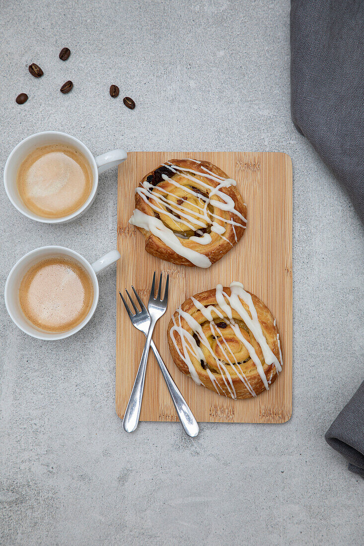 Raisin Pastry on a wooden chopping board with coffee