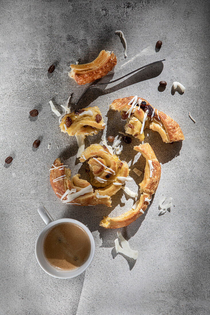 Raisin Pastry on a wooden chopping board with coffee