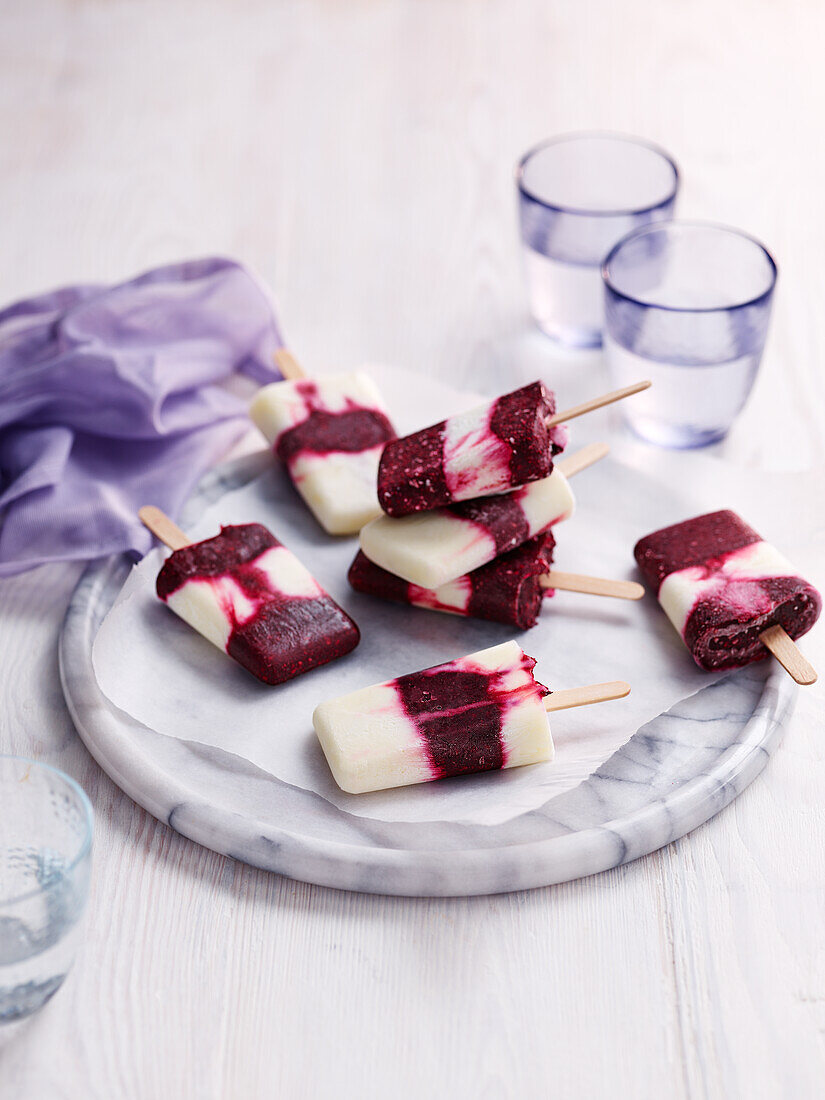 Striped redcurrant yogurt ice cream on a stick