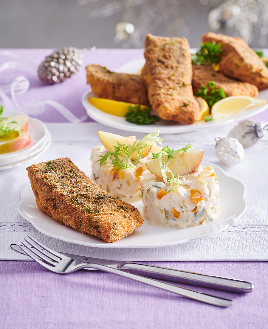 Fried carp in herb crust with potato and apple salad