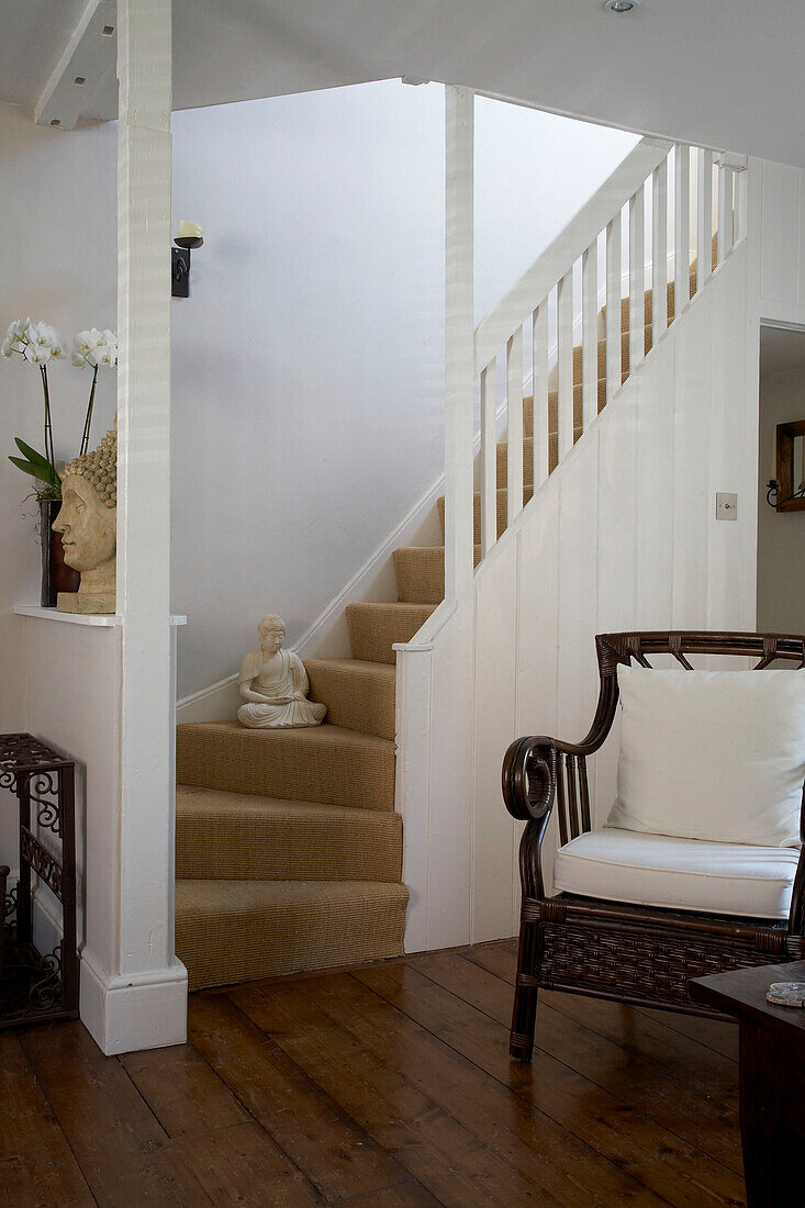 Carpeted stairway with white banisters