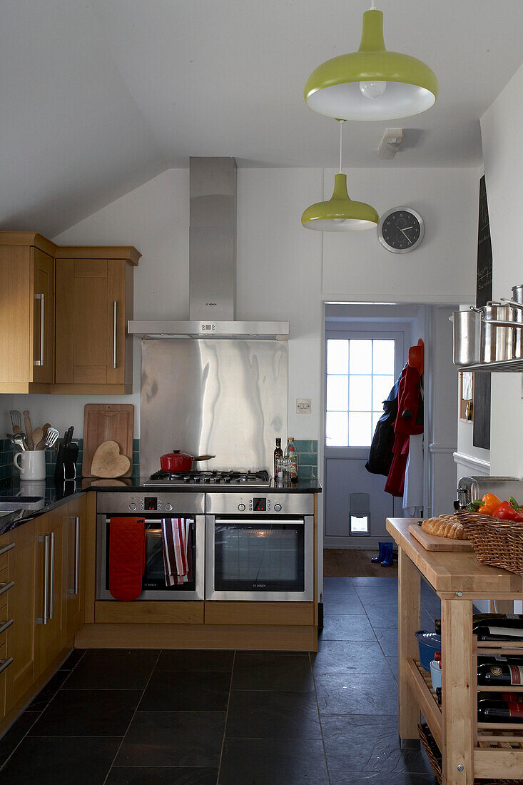 Devon kitchen with stainless steel extractor and wooden butlers block