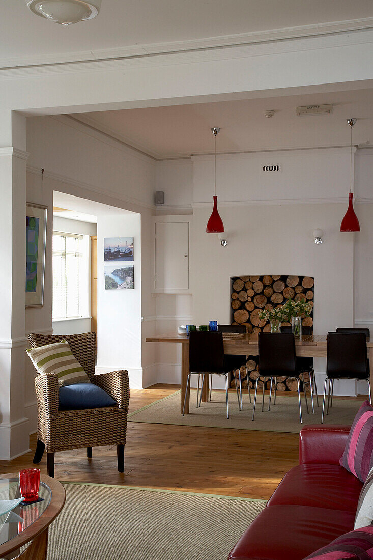 Open plan seating with stacked firewood in Devon living room