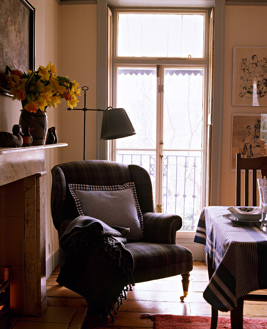 Upholstered armchair next to fireplace