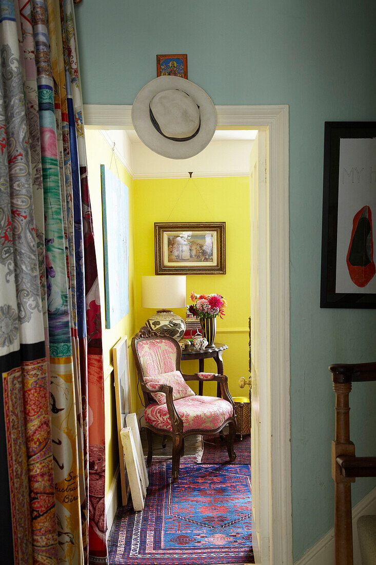 Multicoloured fabric and view through doorway to sunlit room