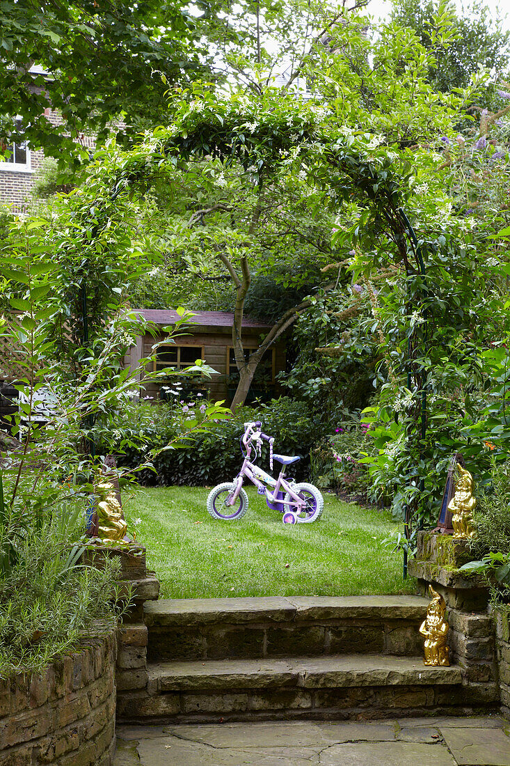 Child's tricycle in back garden of London home