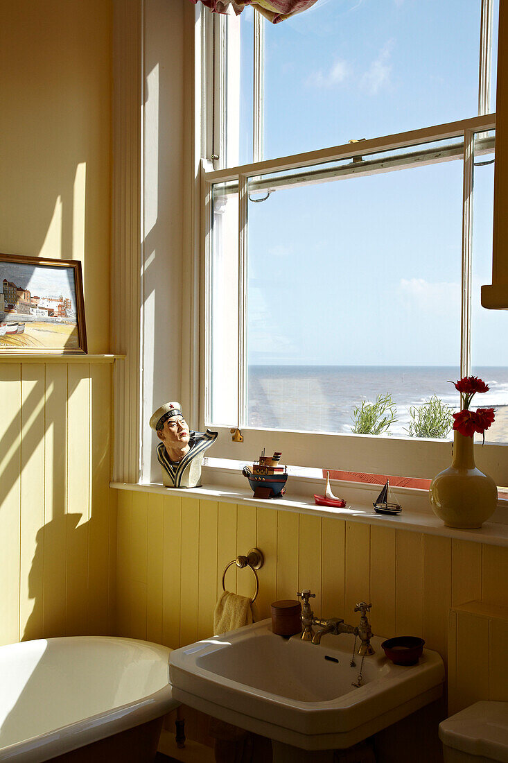 Washbasin below window in Cromer beach house bathroom, Norfolk, England, UK