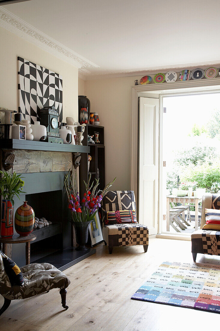 Chairs with patterned covers in front of blue fireplace