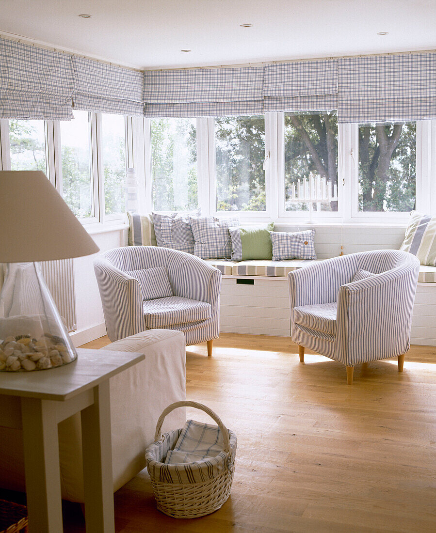 Upholstered armchairs in front of window seat