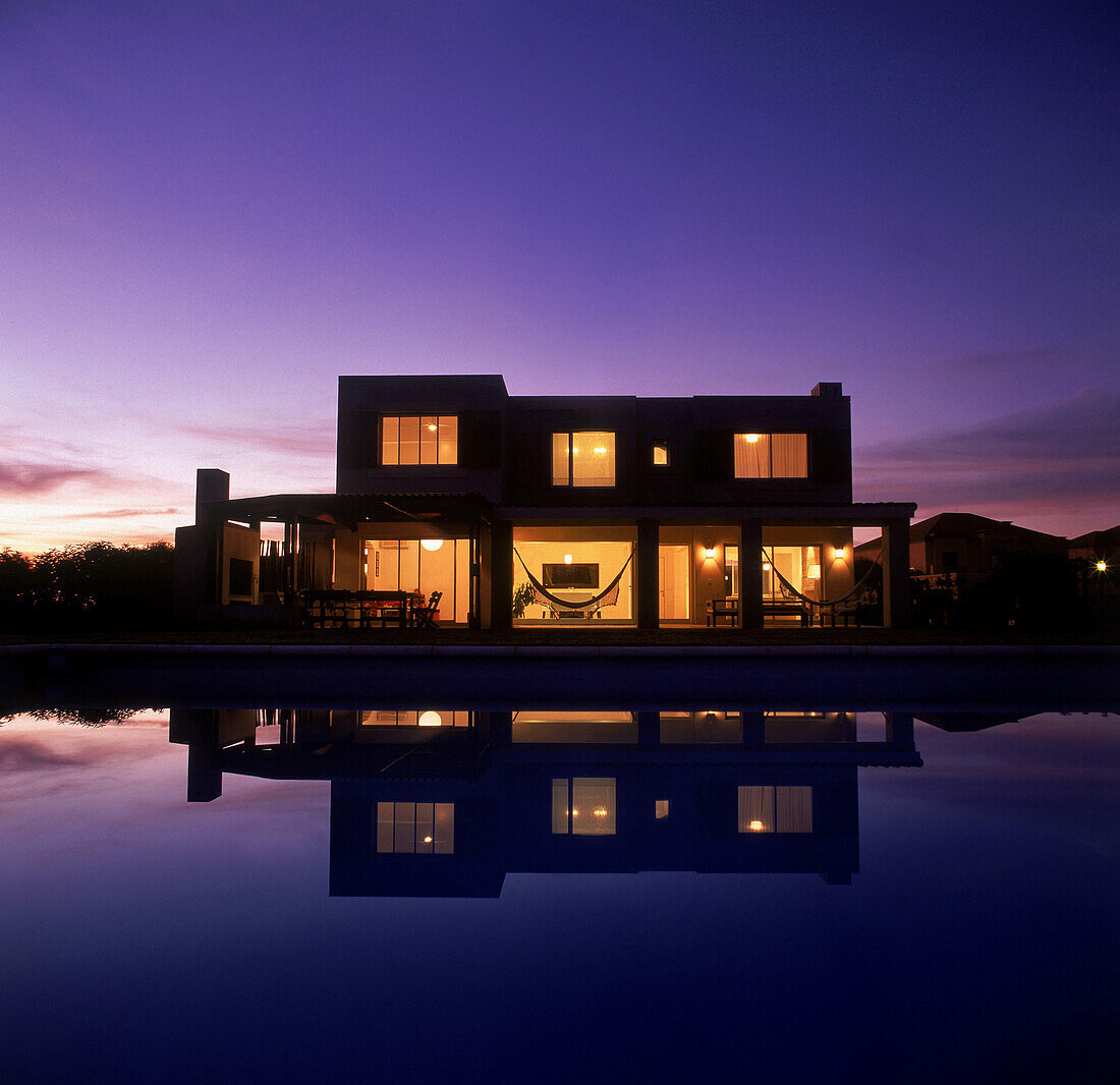 Facade with large windows and swimming pool acting as a water mirror