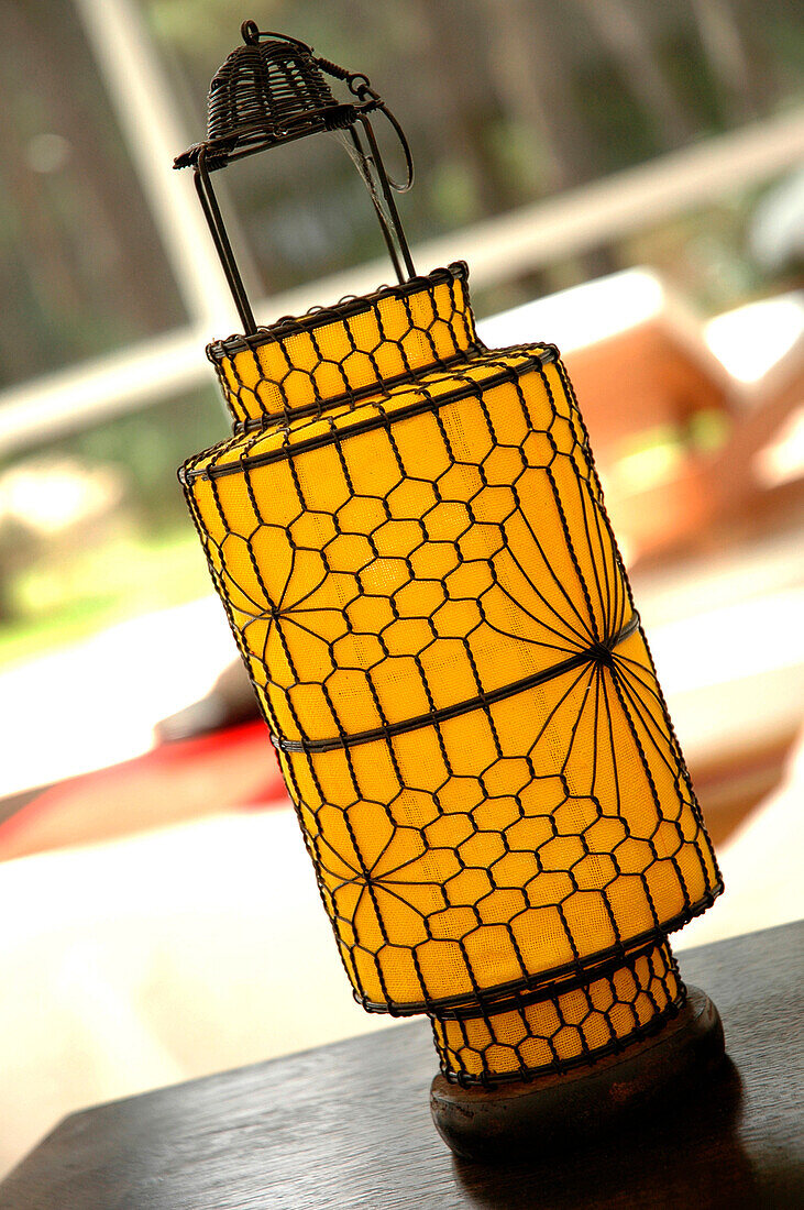 Close up of colourful Chinese style yellow cloth and wirework lantern in modern living room