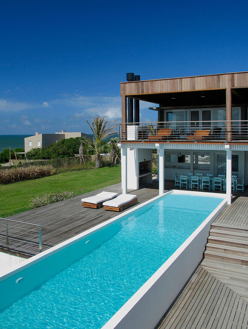 Holiday home exterior with swimming pool and balcony terrace