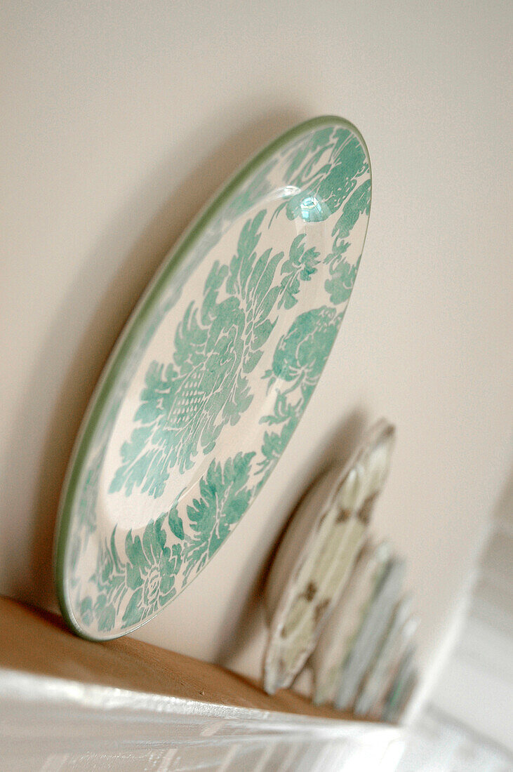 Decorative plate with floral pattern on shelf