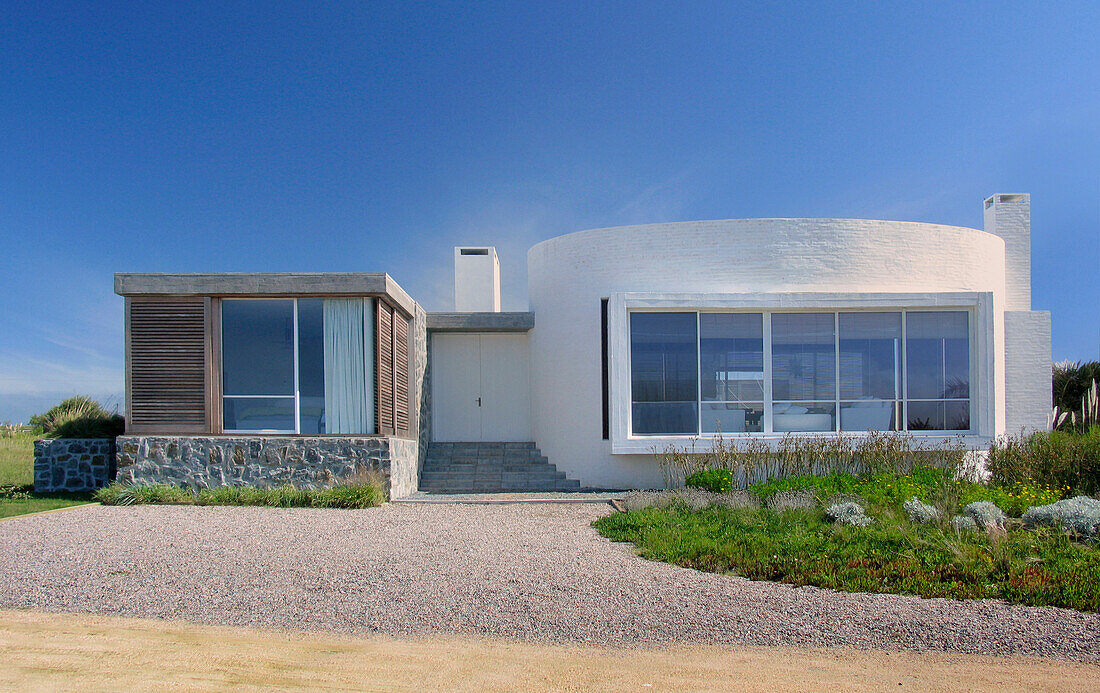 Oval shaped house made of furring brick with reinforced concrete and grey granite stone walls