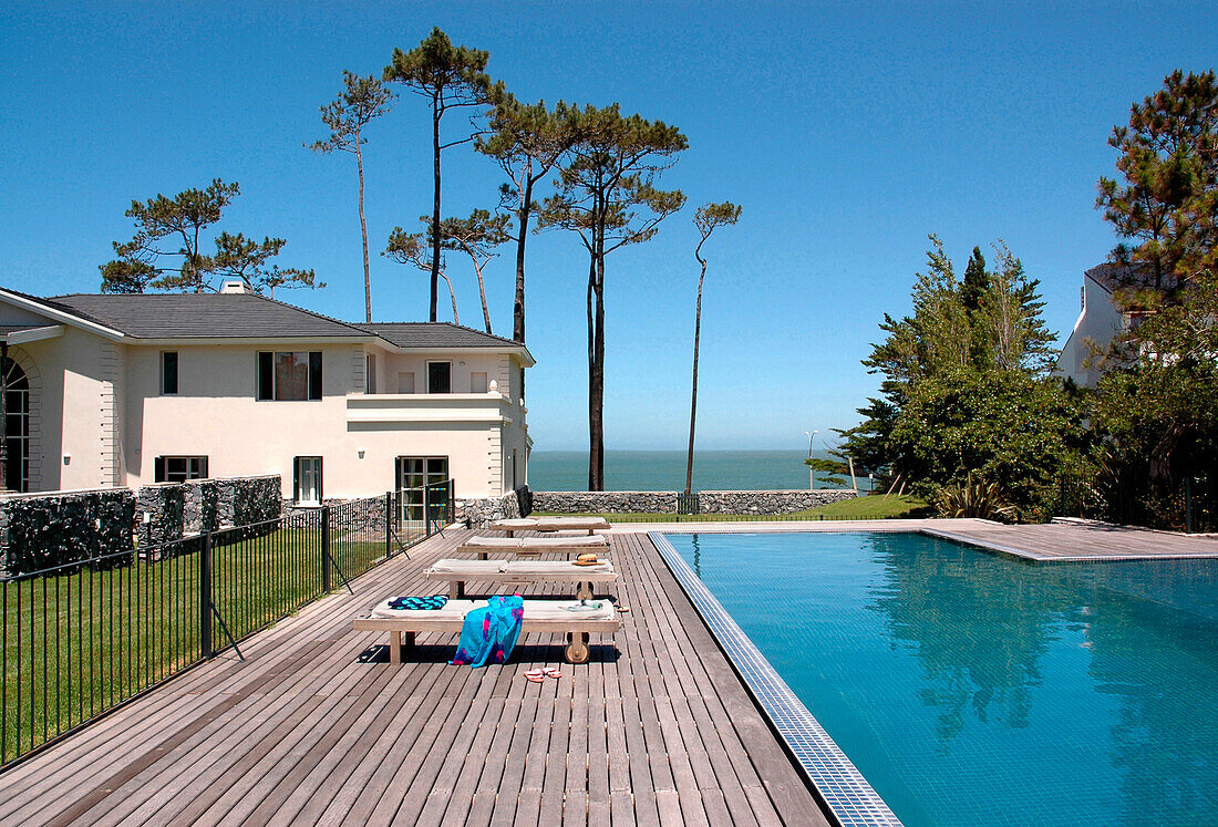 Beach house exterior with poolside decking