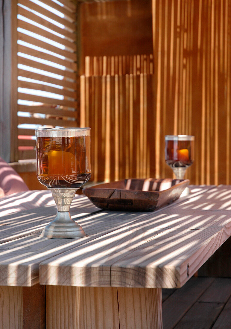 Two glasses of beer on wooden tabletop