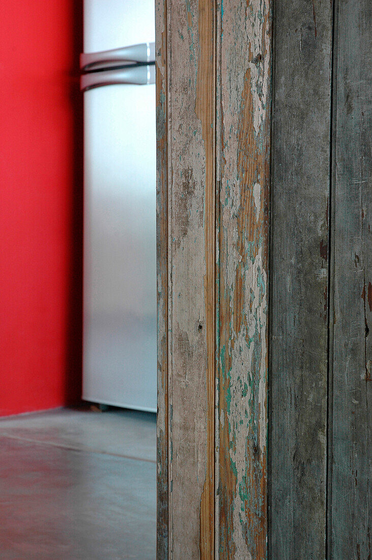 Recycled kitchen counter fridge and plastered walls painted red