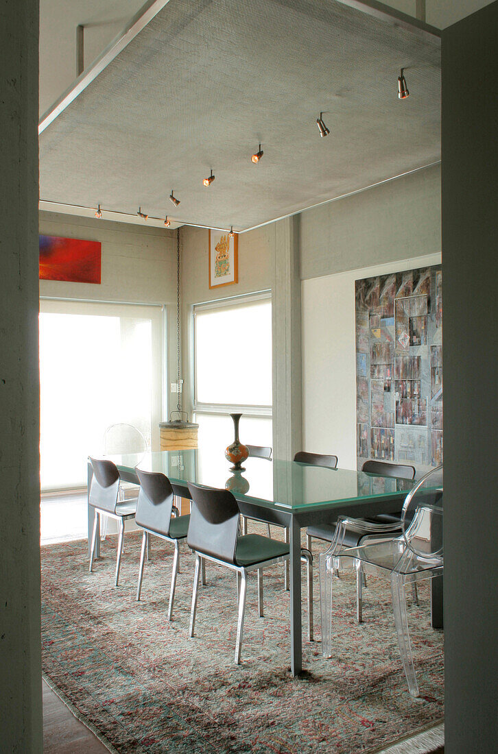 Dining room table beneath lowered ceiling of city apartment