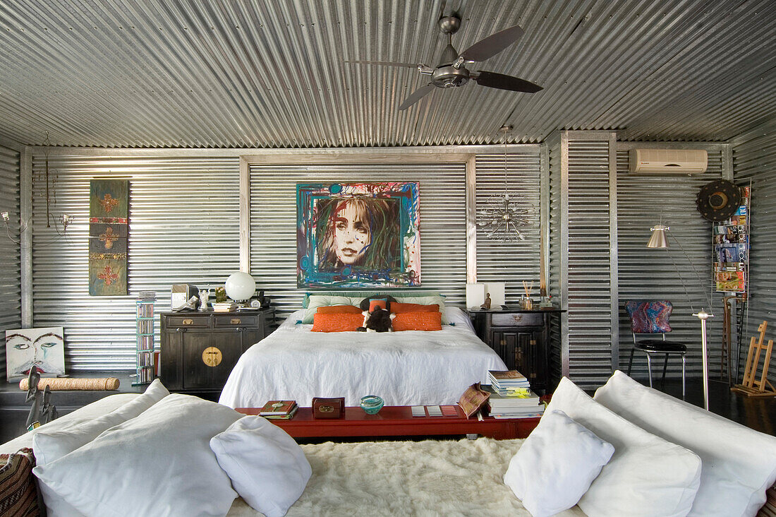 Bedroom with galvanized metal and Chinese furniture rabbit fur covered chaise longue