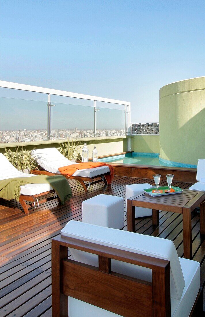 Sun loungers next to swimming pool on roof garden, Buenos Aires, Argentina