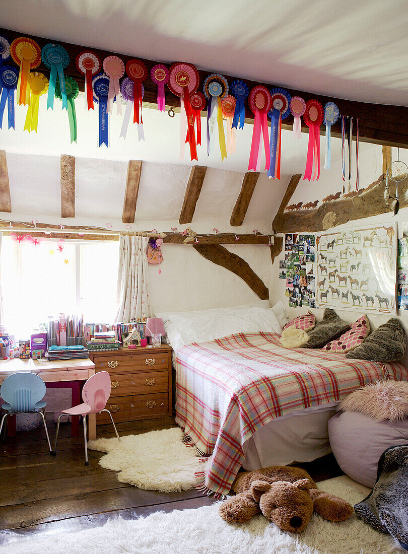 Rosettes pinned to beam of child's bedroom in 17th Century Oxfordshire home