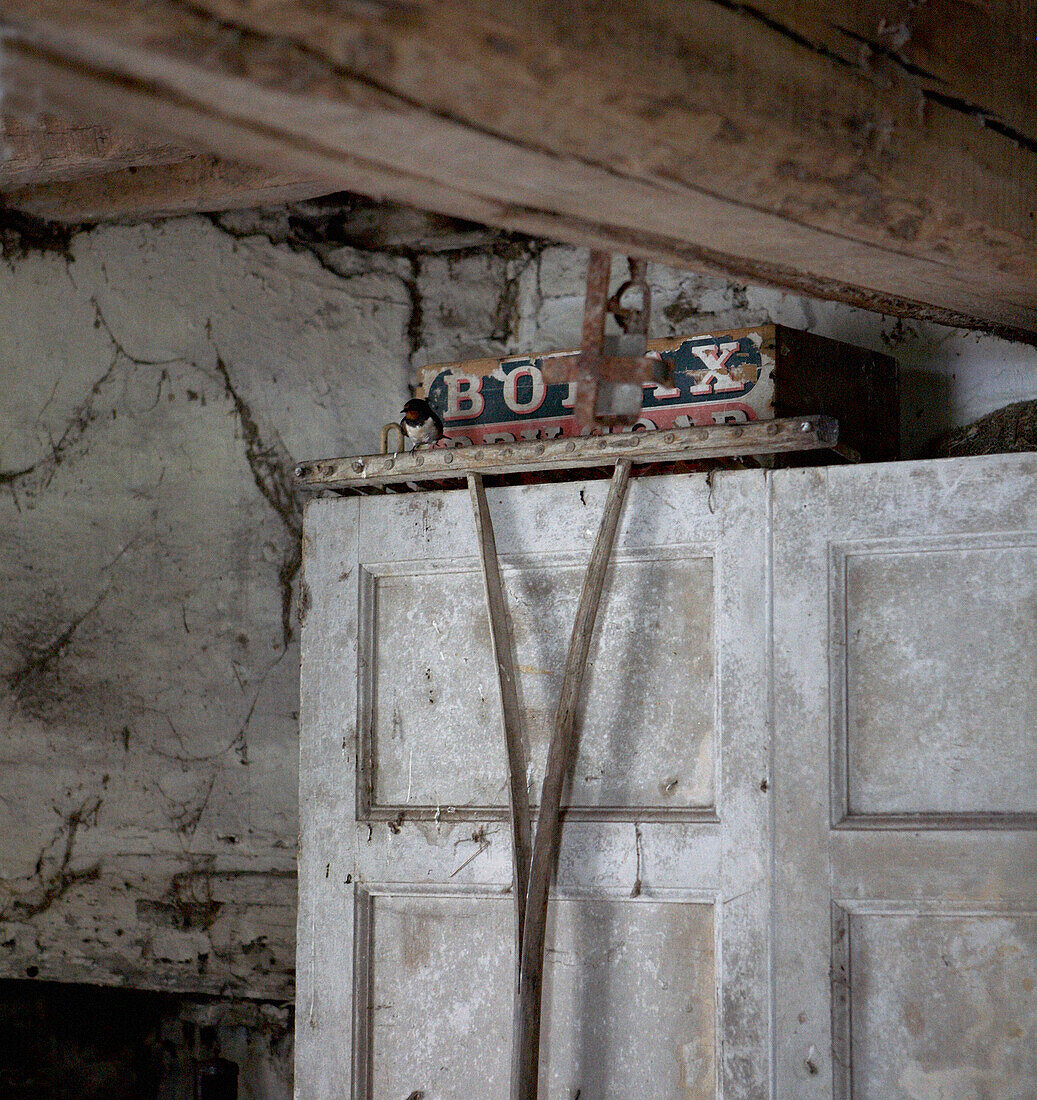 Forgotten toy box on top of cupboard with cobwebs 