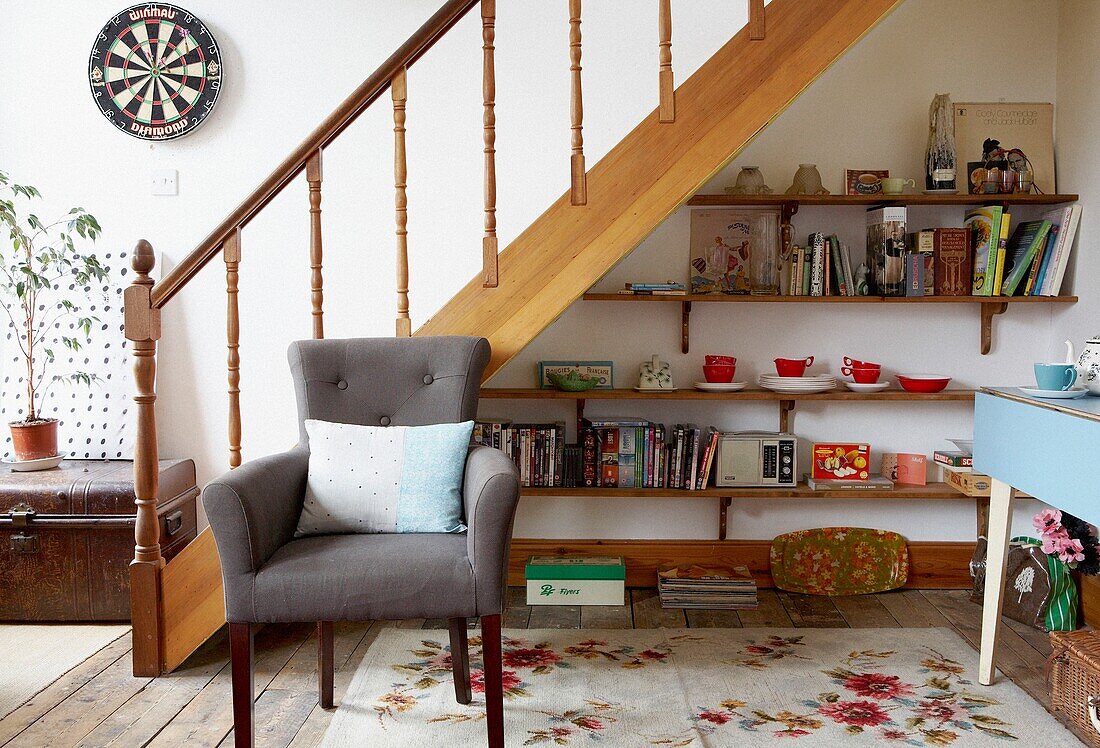 Grey armchair and under stairs shelving