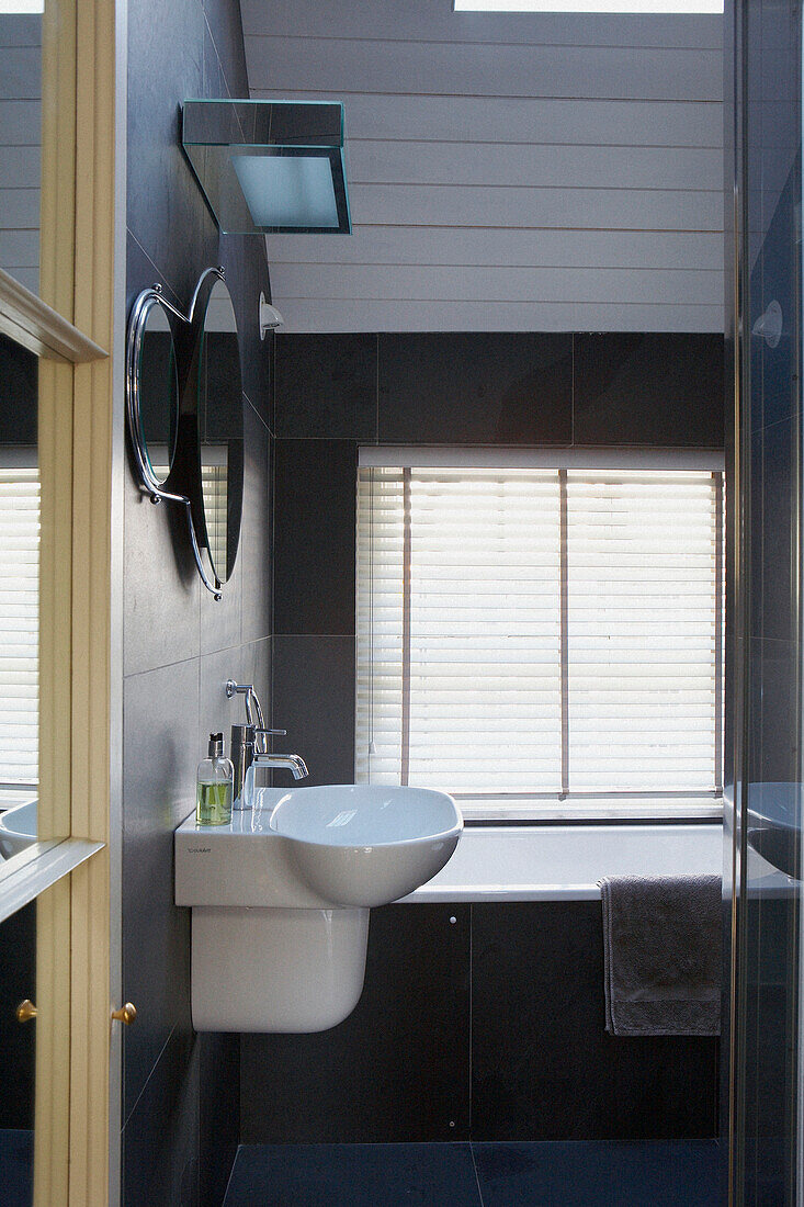 Black tiled bathroom of 1820s Georgian townhouse conversion