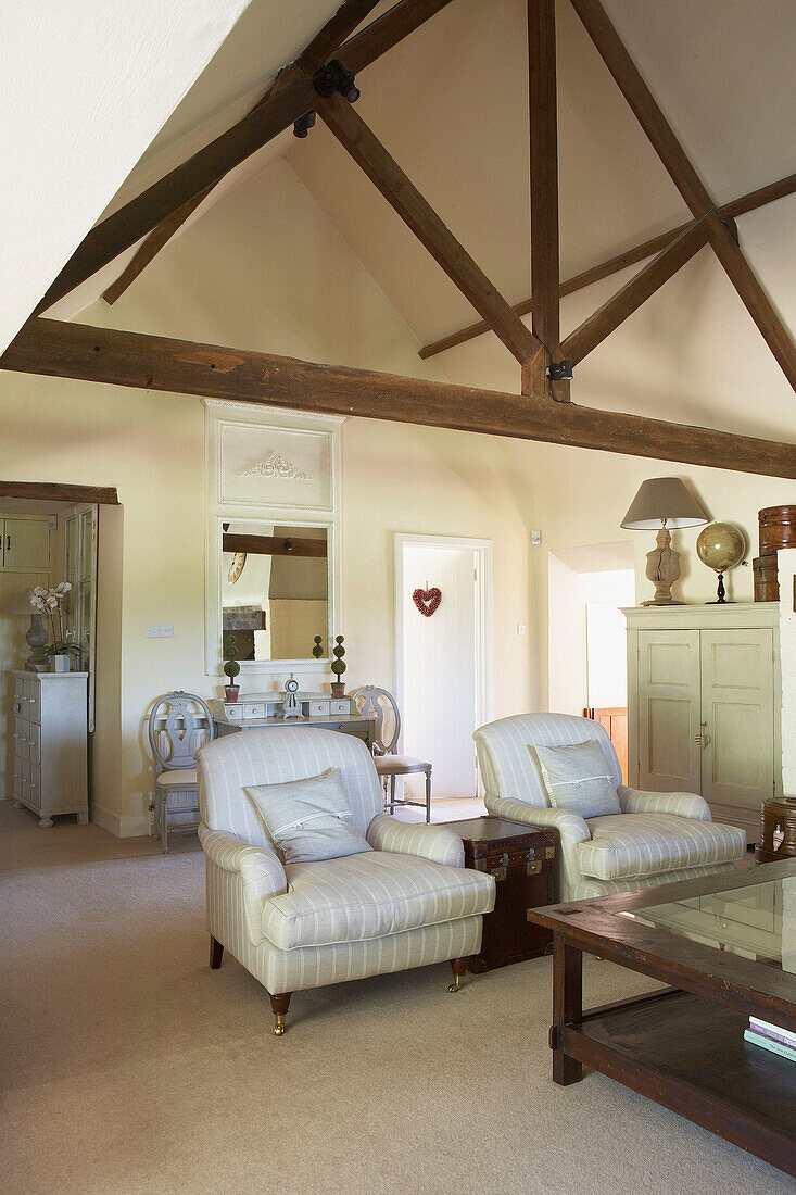 Striped armchairs in beamed farmhouse conversion