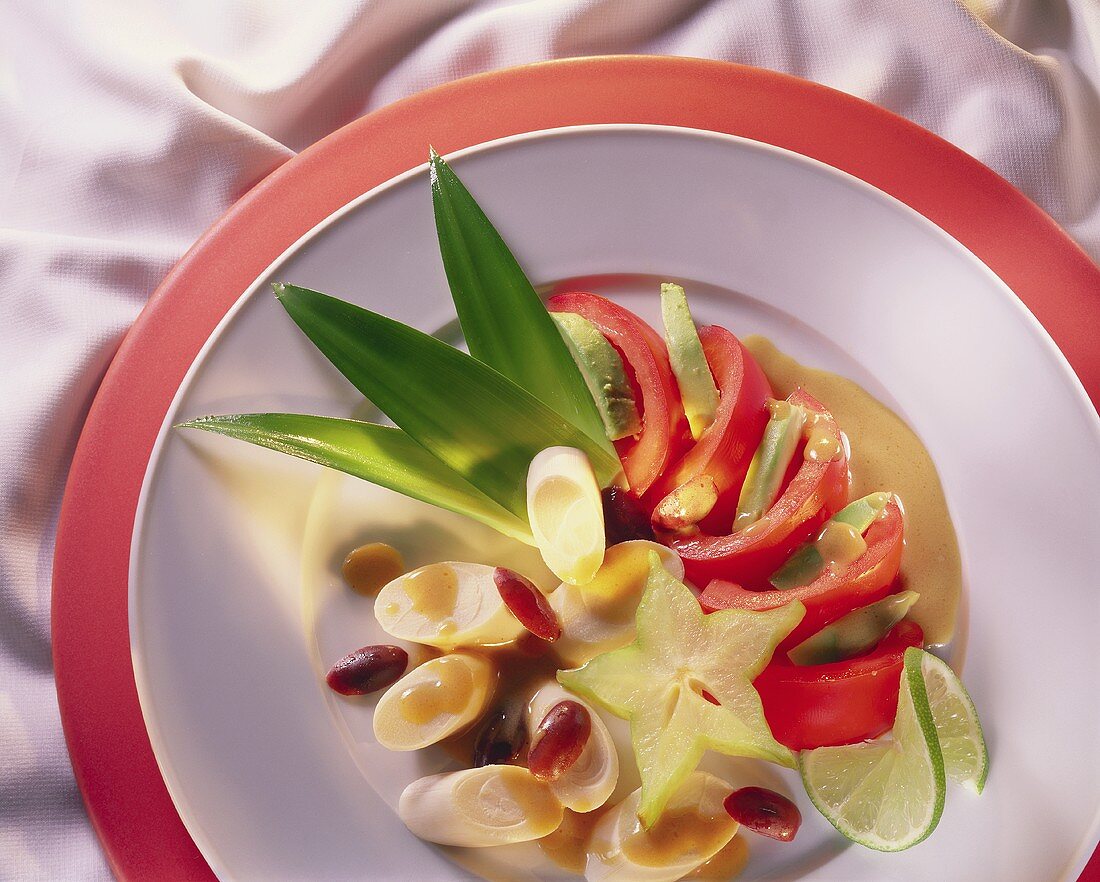 Tropical salad with palm hearts, carambola, tomatoes, avocado