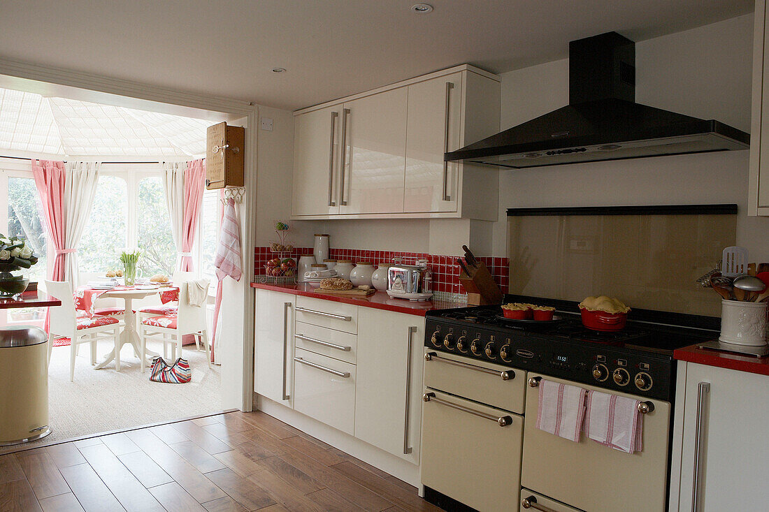 Range oven with extractor in kitchen with conservatory extension