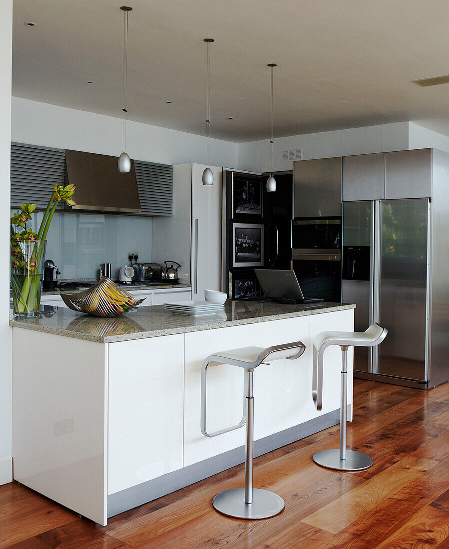 Open plan apartment kitchen with stainless steel appliances 