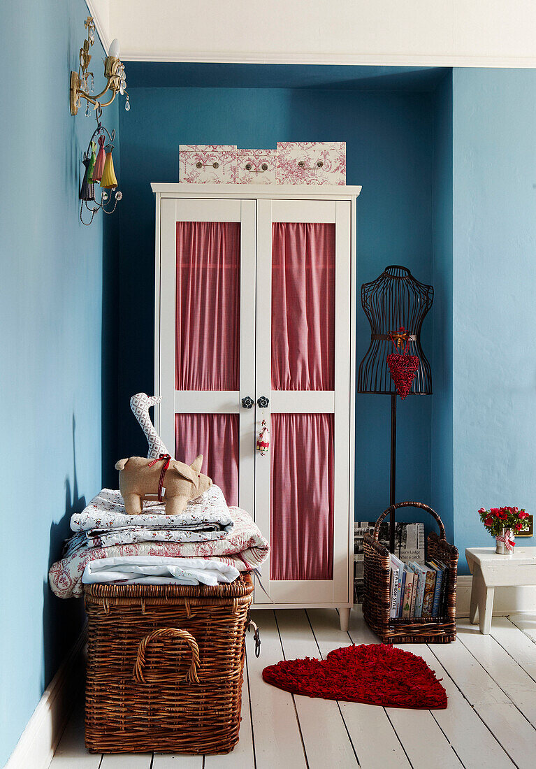 Red checked fabric lines painted wardrobe in Edwardian bedroom