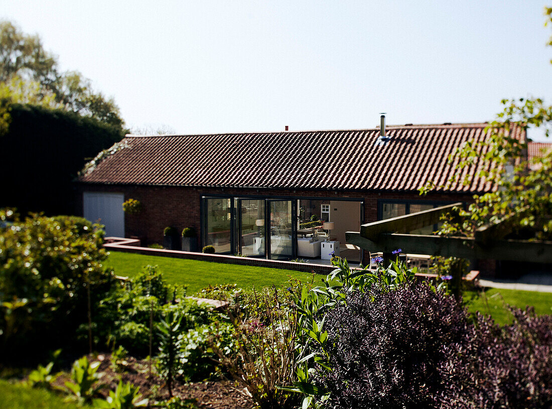 Barn conversion with open doors to back garden