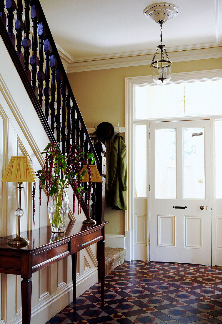 Wooden banister in tiled hallway of Birmingham townhouse